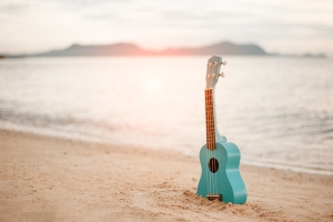 There's a blue guitar stuck in the sand